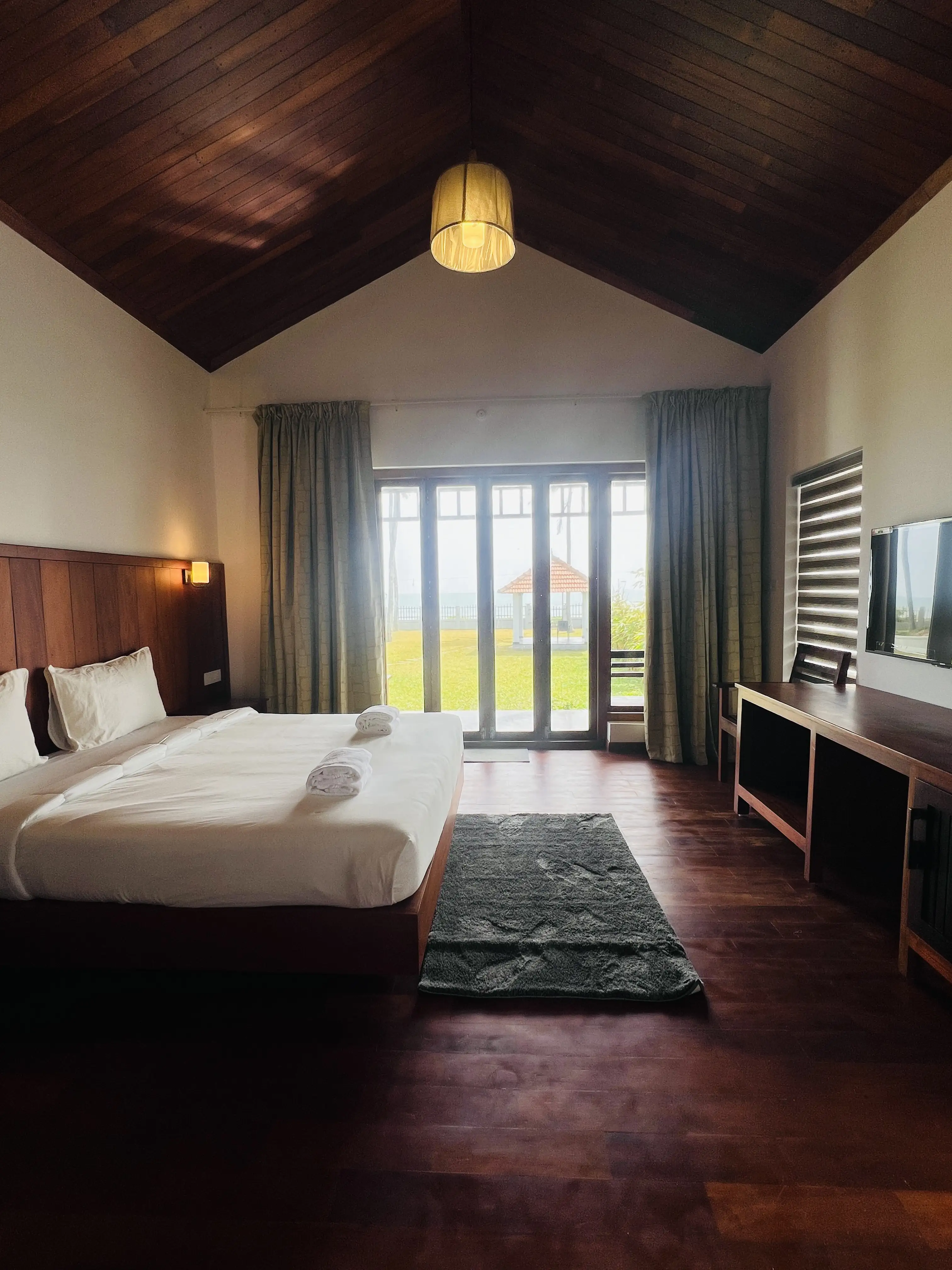 Bedroom with full-length glass doors opening to the sea