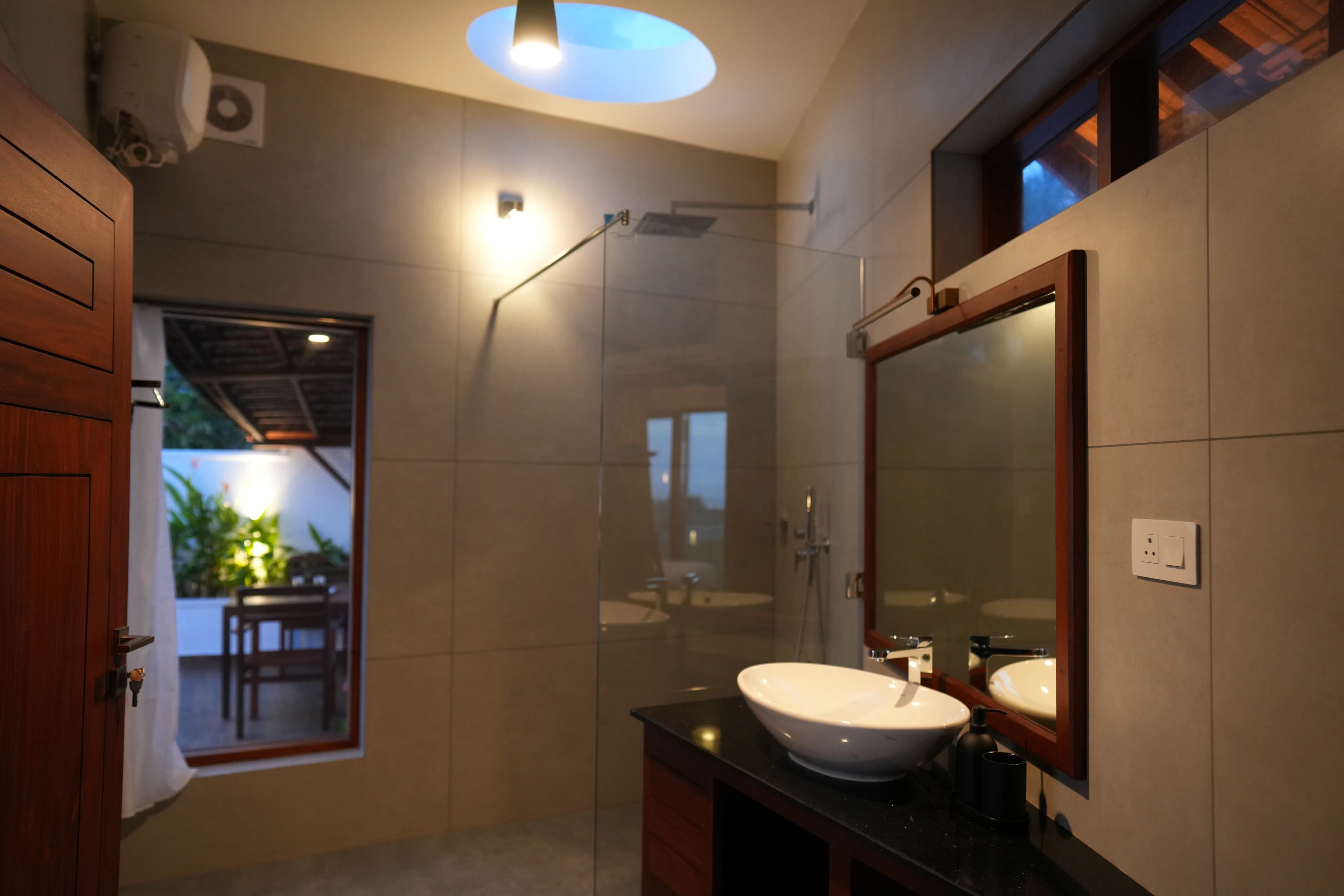 Bathroom with sky view rain shower